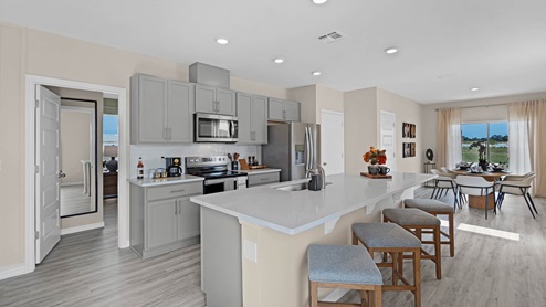 Kitchen with island and door to the primary bedroom