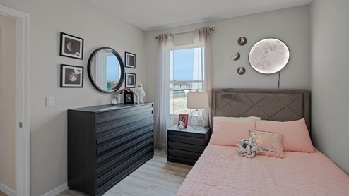 Guest bedroom with full size bedroom and vanity