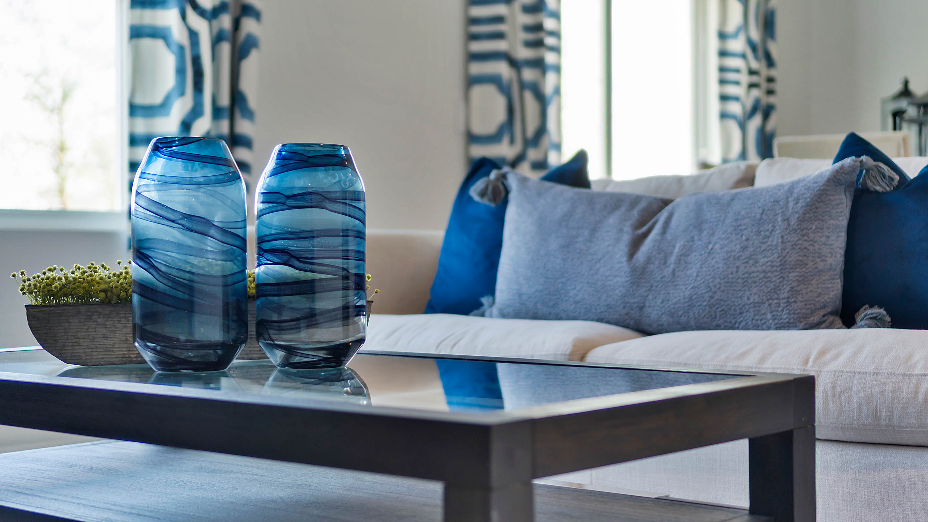 Living room view of kitchen and dining nook with sliding glass doors