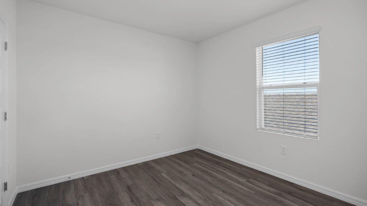 guest bedroom unfurnished with window facing the side of the home