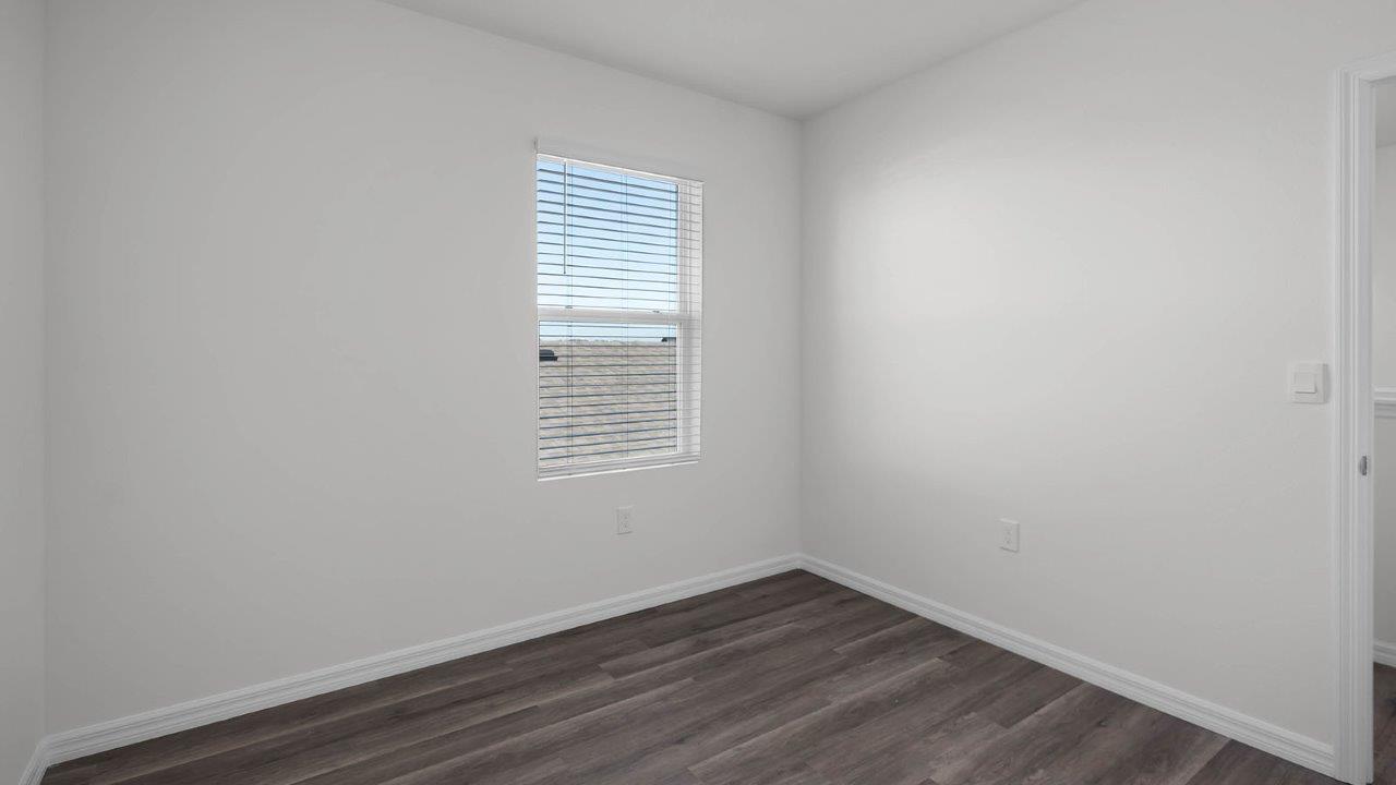 guest bedroom unfurnished with window facing the side of the home
