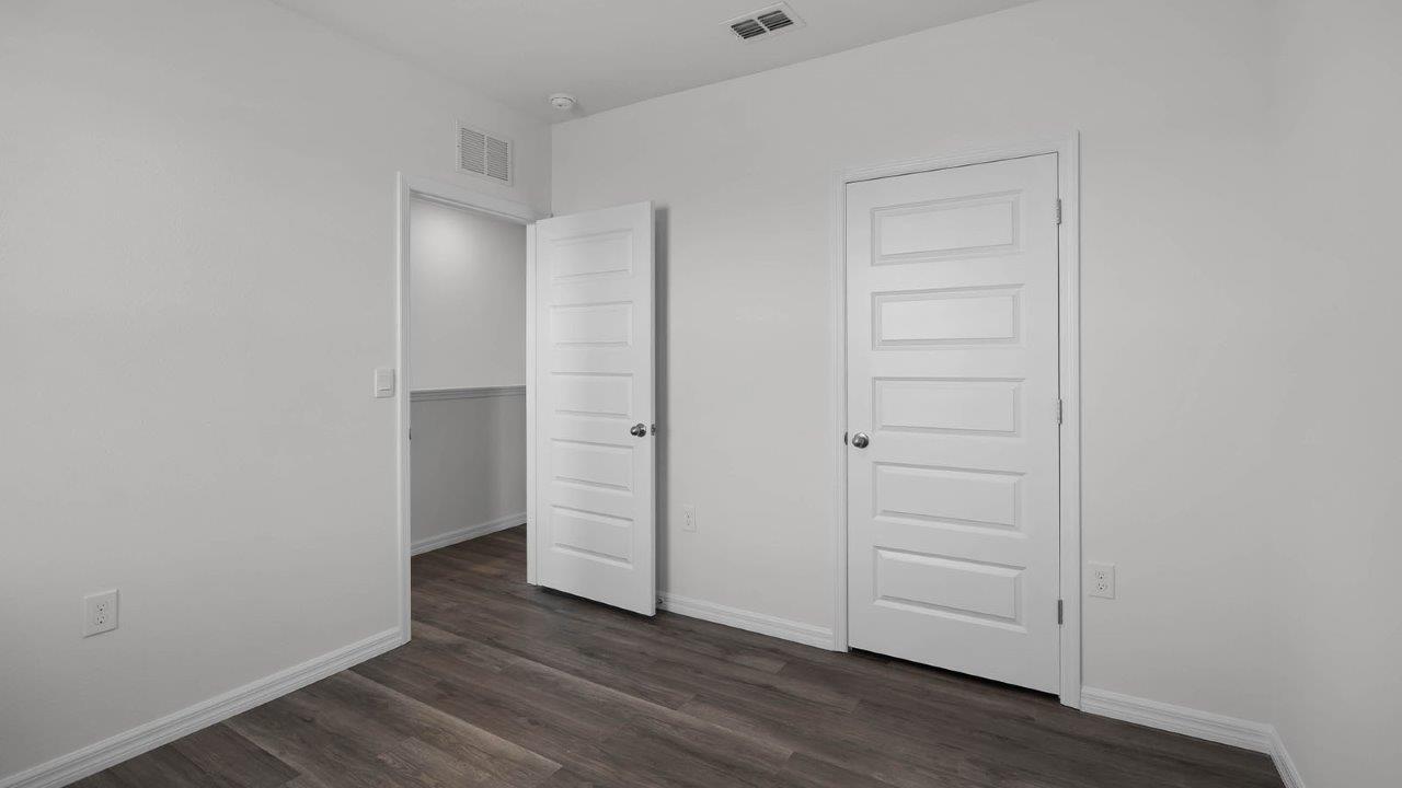 guest bedroom unfurnished with closet