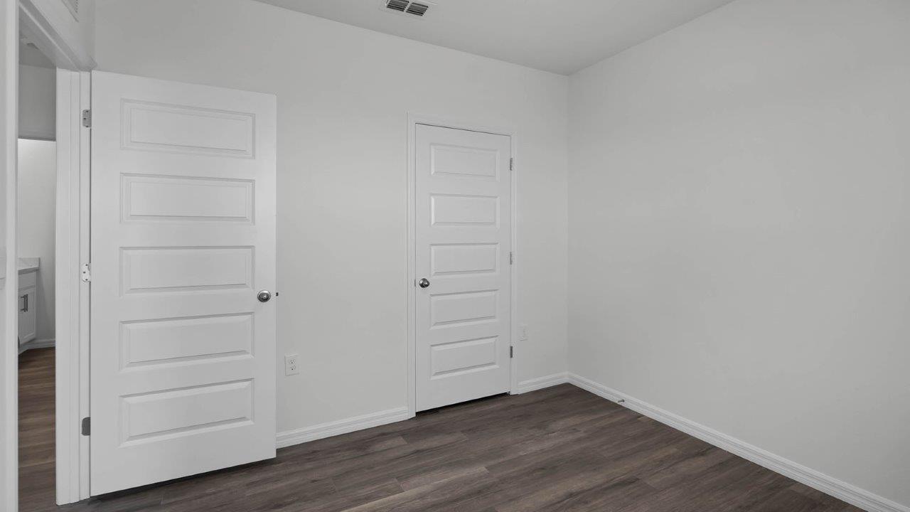 guest bedroom unfurnished with closet