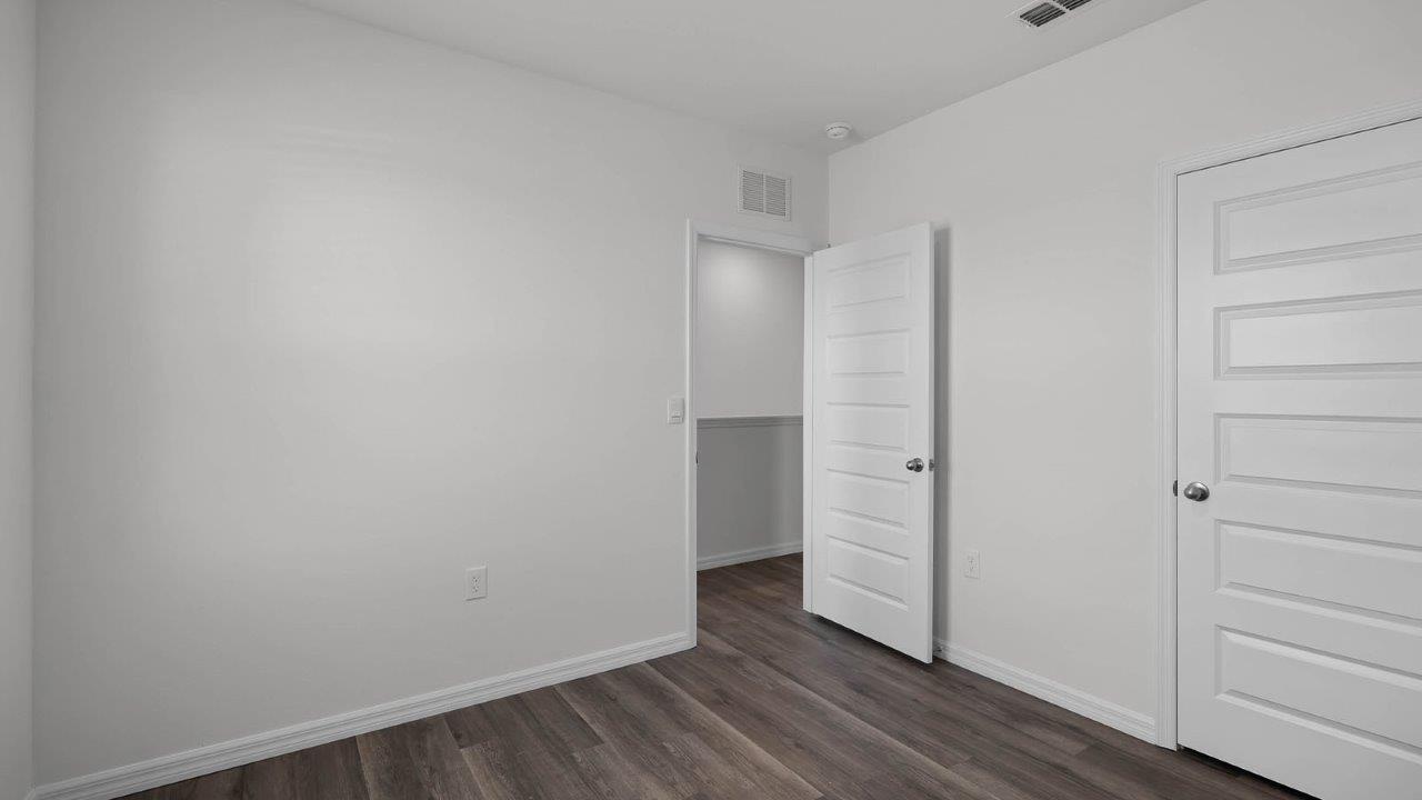 guest bedroom unfurnished with closet
