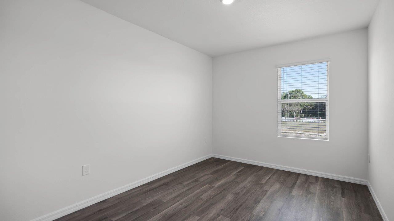 second guest bedroom with window facing the yard