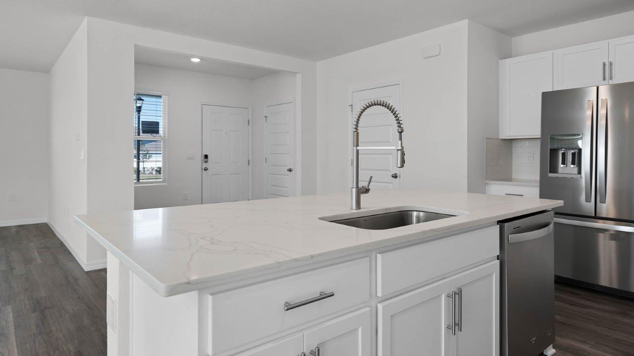 Close up of Kitchen Island and sink with stain steel appliances