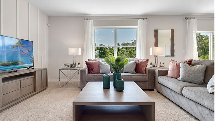 Living room with window and sliding glass door facing the backyard