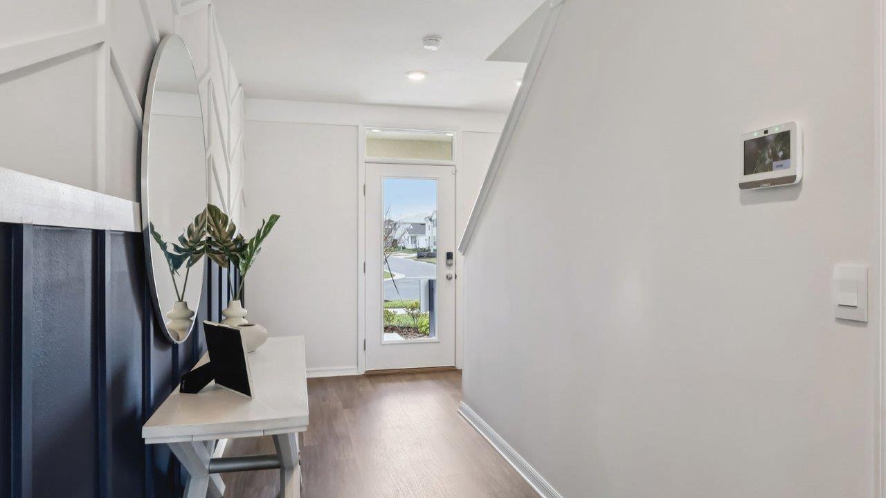 Entryway decorated with table and mirror