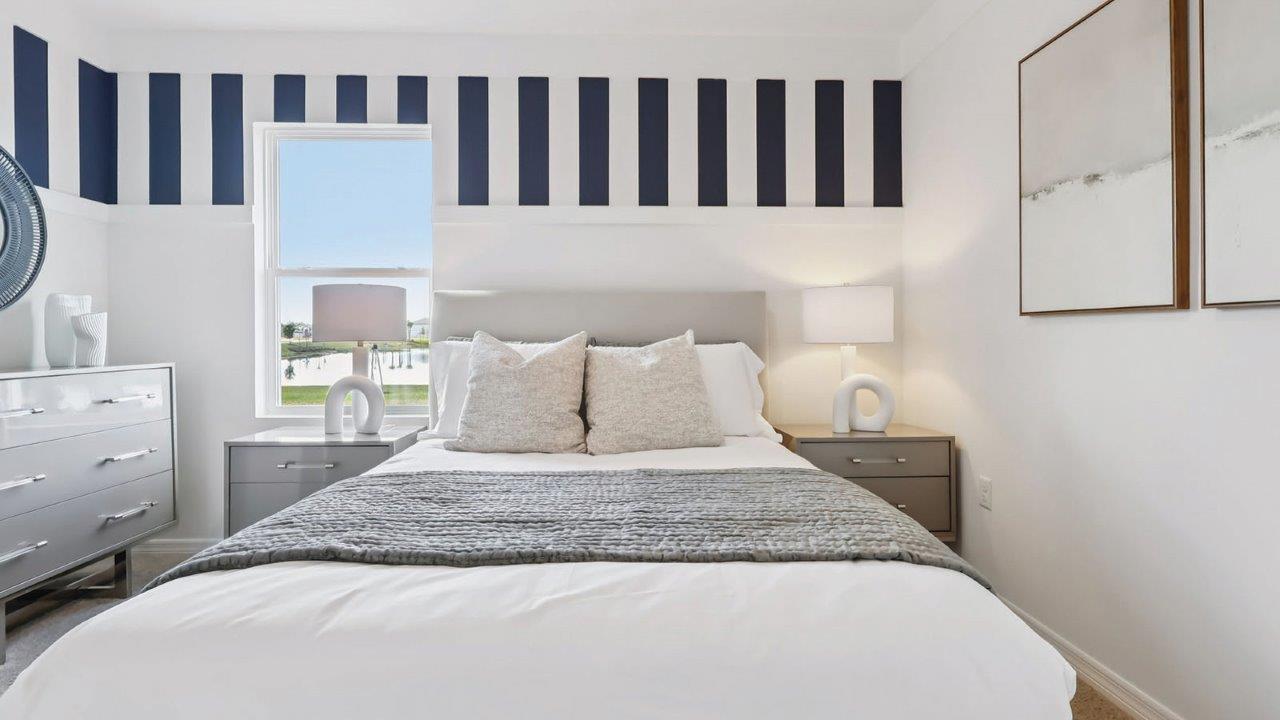 Bedroom with wall accents and a queen size bed