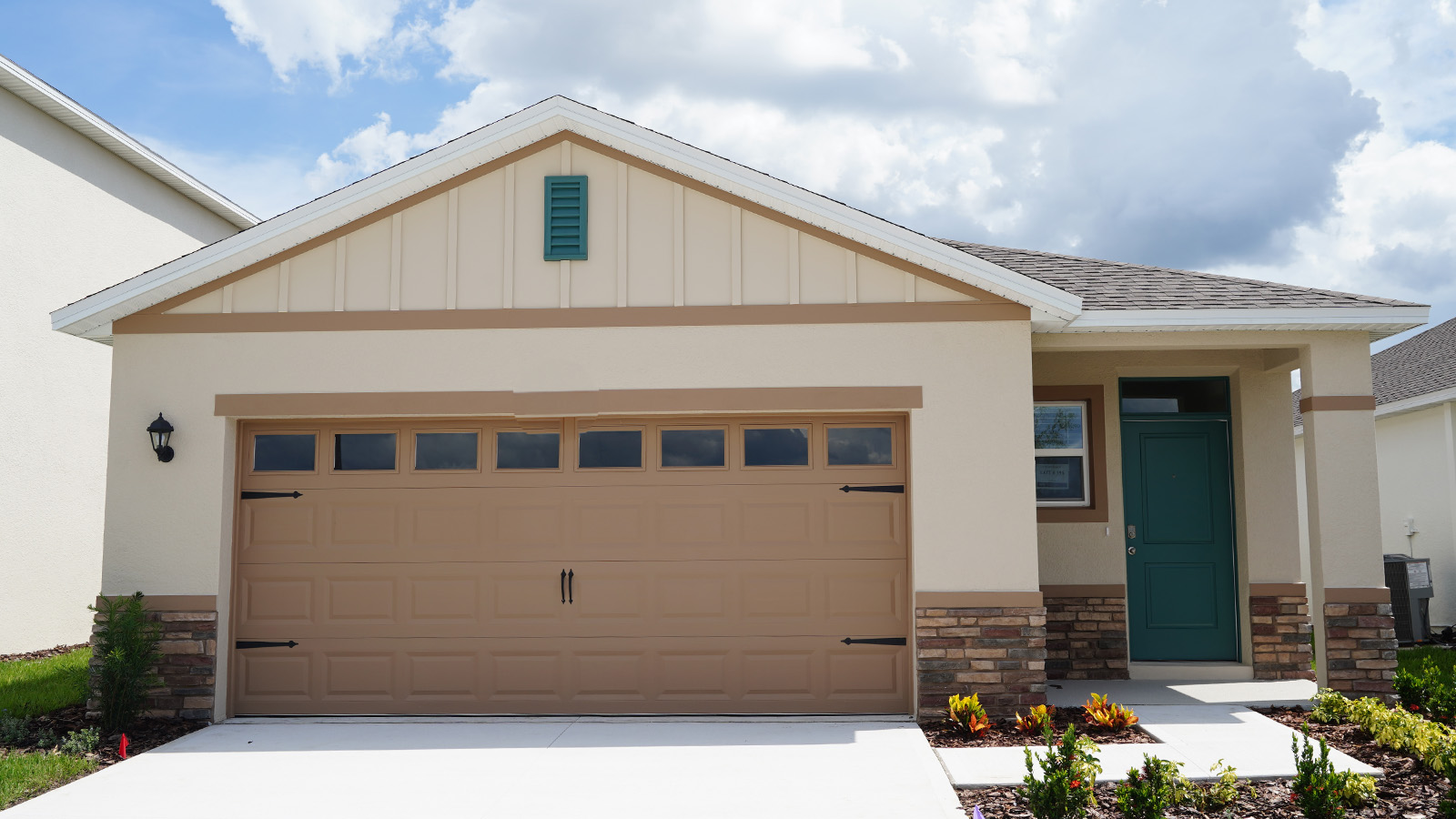 One story single-family home with two-car garage and stone