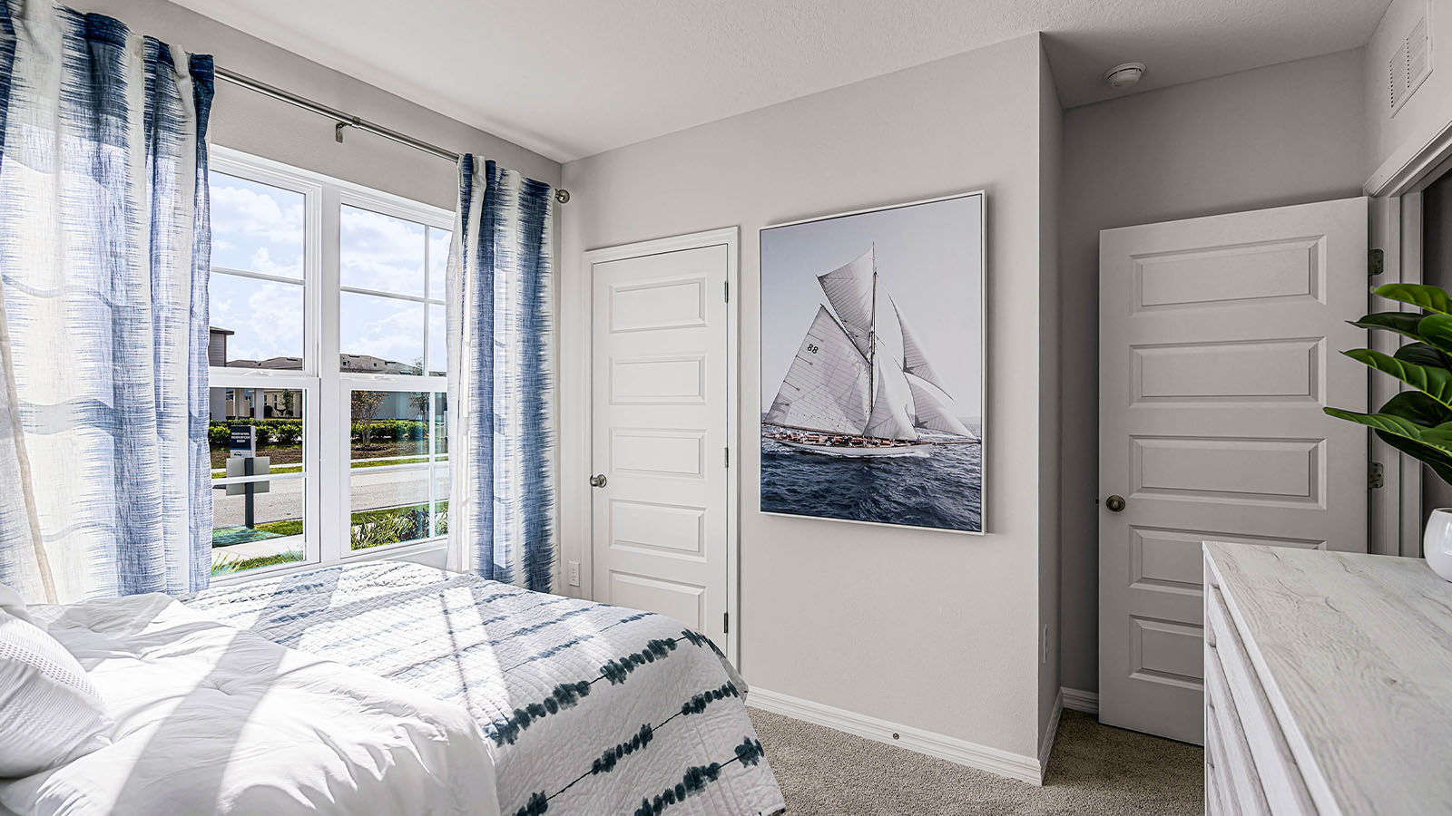 guest bedroom with window facing the front of the home