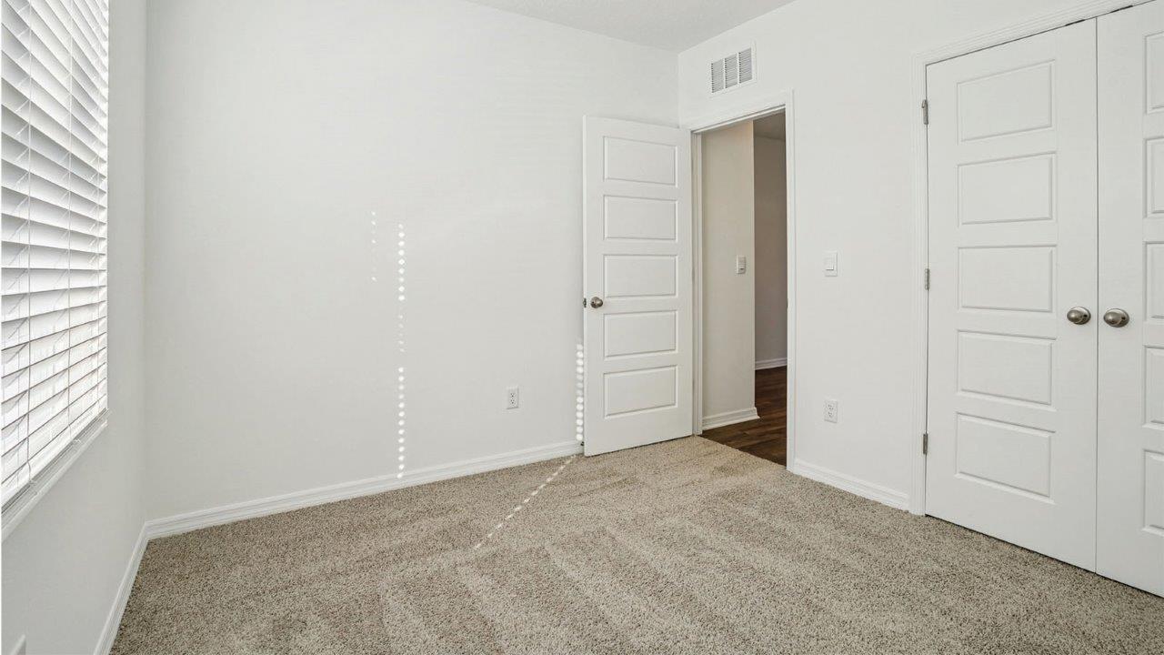 guest bedroom with carpet