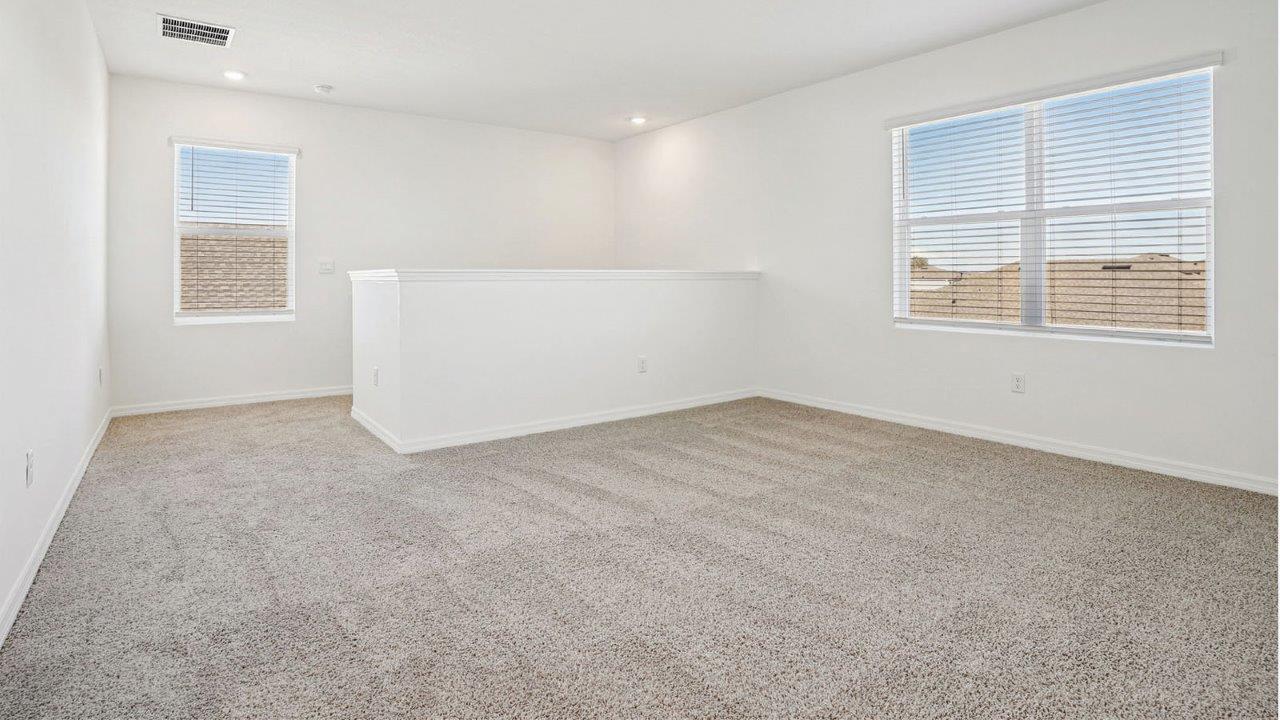 upstairs loft with window and carpet