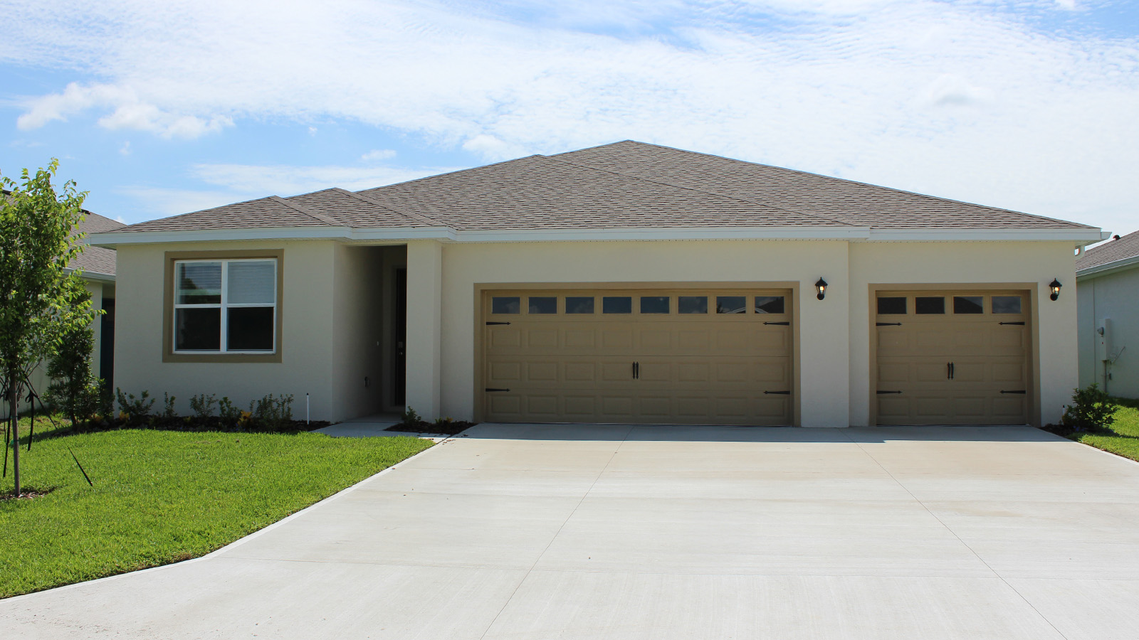 Exterior single family home with three car garage