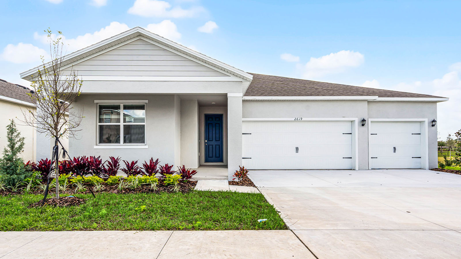 Exterior single family home with three car garage