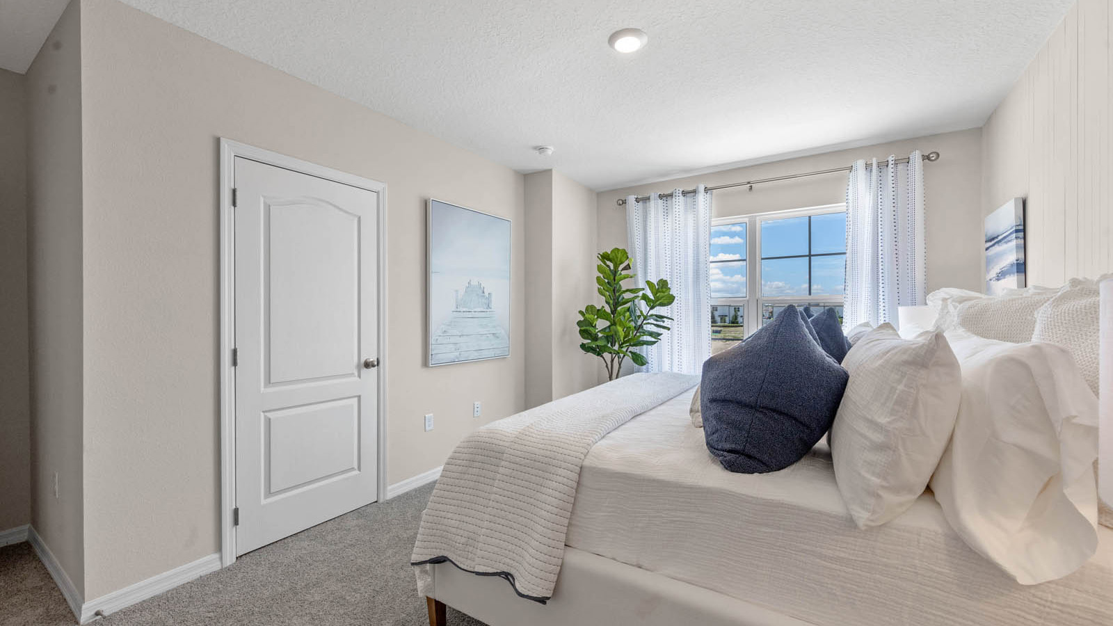 Primary bedroom with walk in closet and king size bed