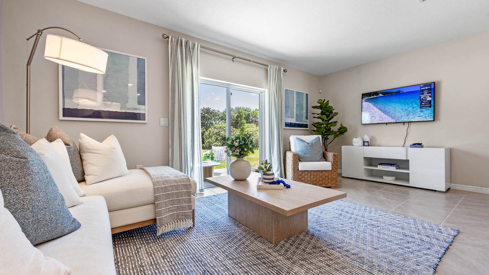 Living room with couch and T.V. set up looking to the patio