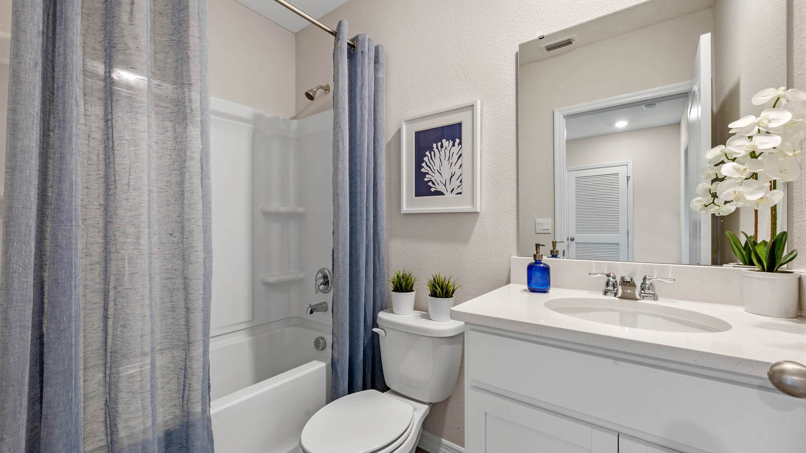 Guest bathroom with tub and single vanity sink