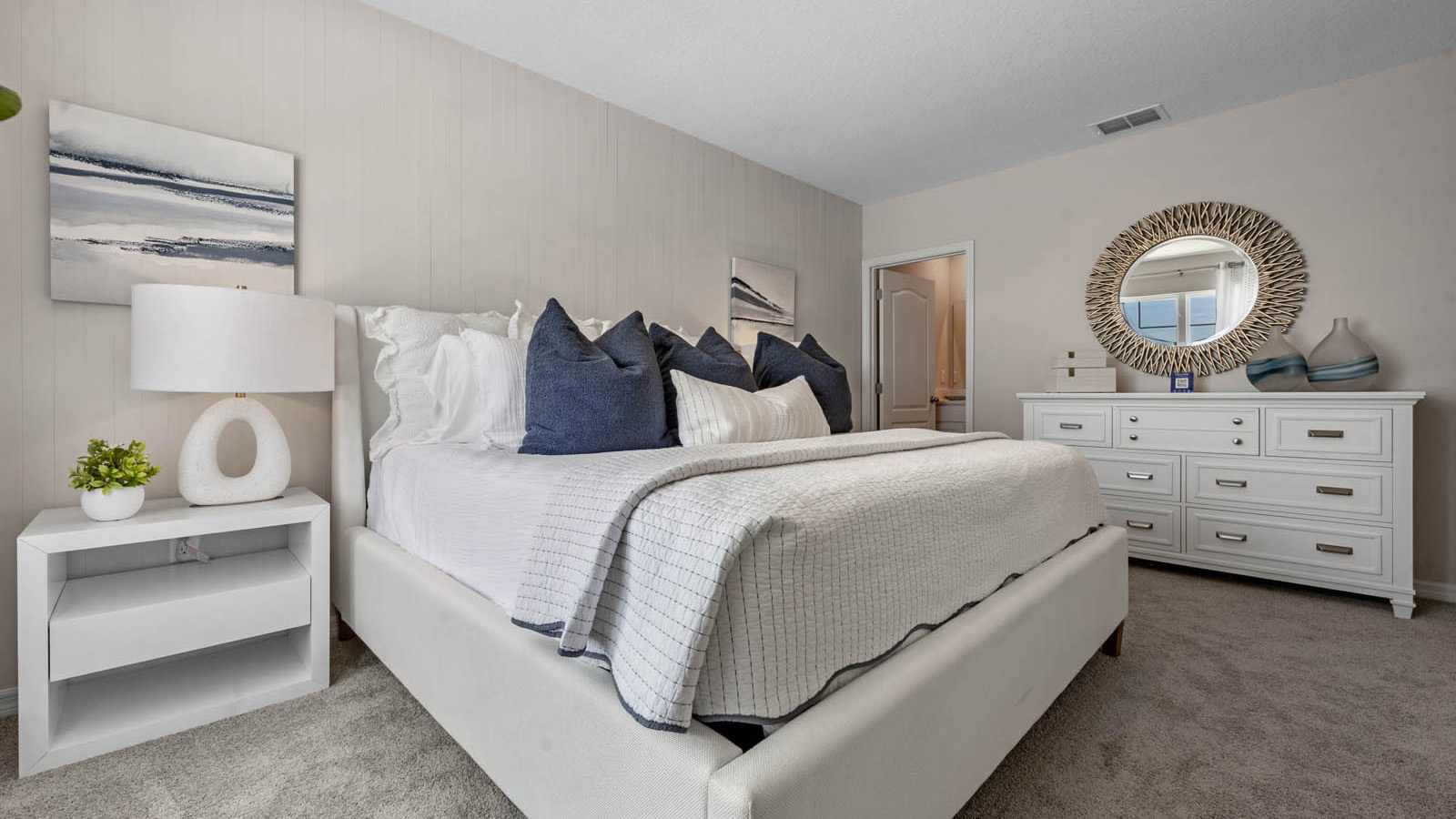 Primary bedroom with entrance to bathroom