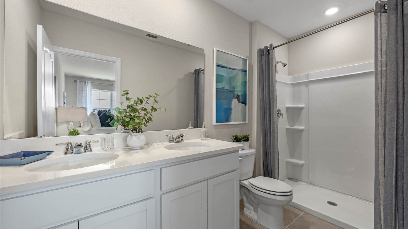 Primary bathroom with double vanity sinks and walk in shower