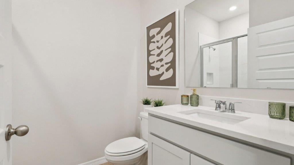 guest bathroom with single sink,toilet and shower