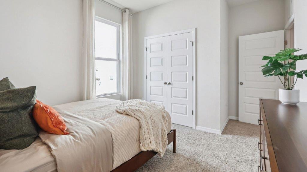 guest bedroom with built in closet and window