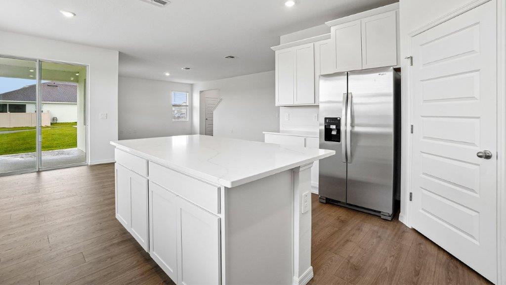 Kitchen with stainless steel appliance and large island in the middle of the kitchen