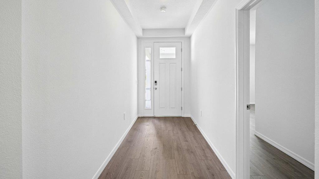 entry way of the home with luxury vinyl planks throughout leading to the rooms