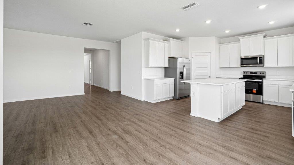 Living room with a kitchen area and large island