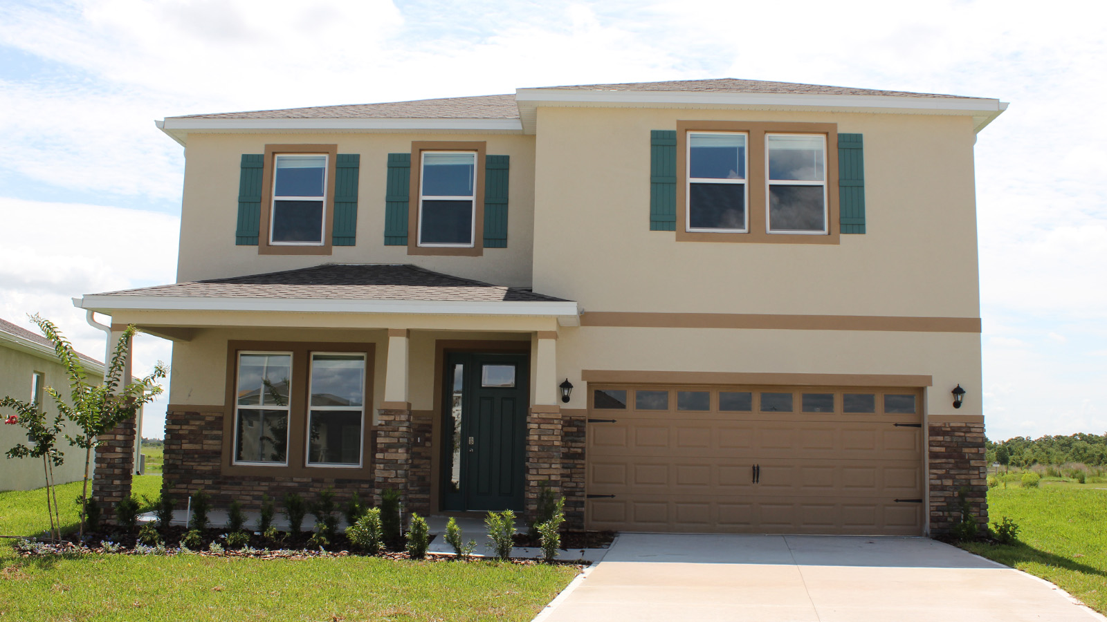 Exterior single family home with two car garage and front porch
