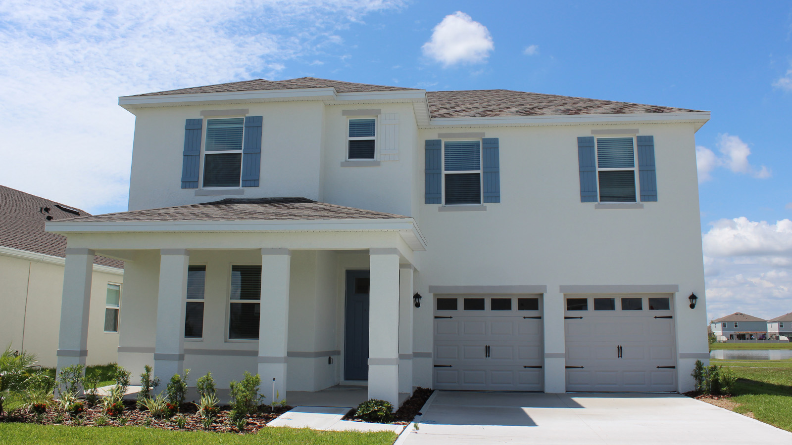 Exterior single family home with two car garage and front porch