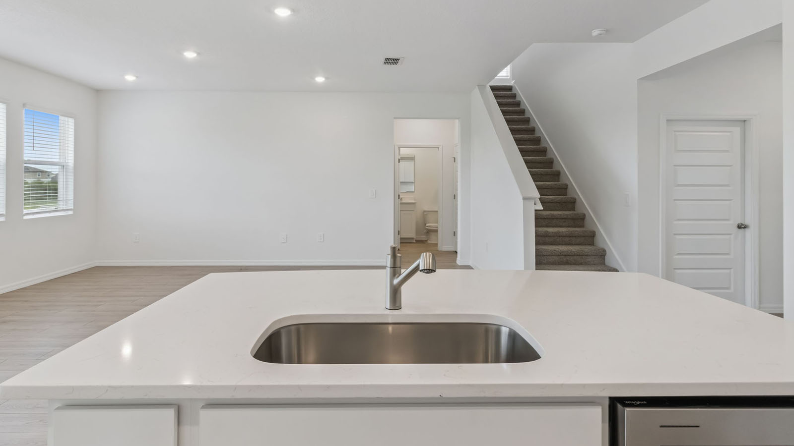 Kitchen island overlooking living room and stairs