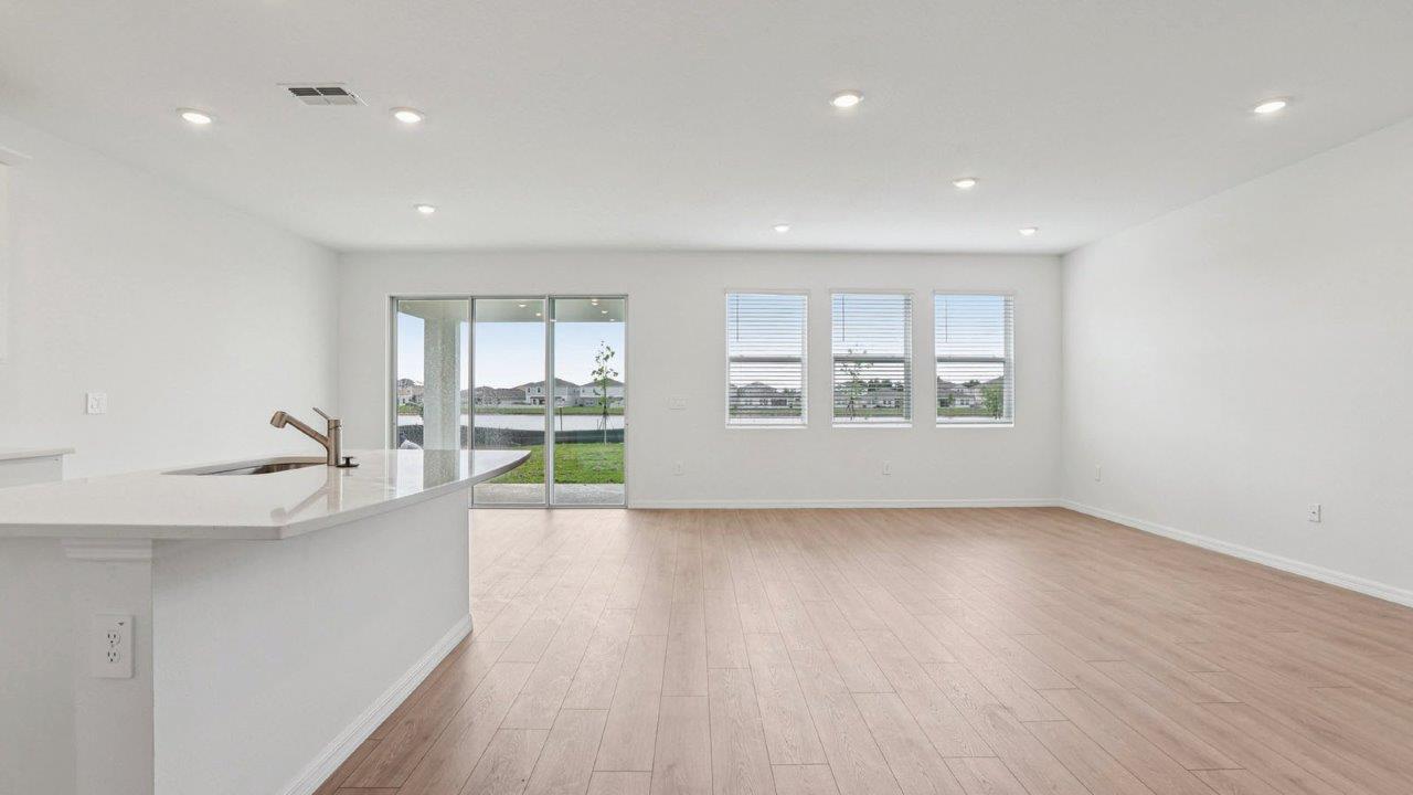 Living Room with Revwood flooring throughout and view of the kitchen island