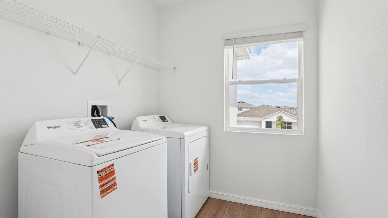 laundry room with revwood flooring