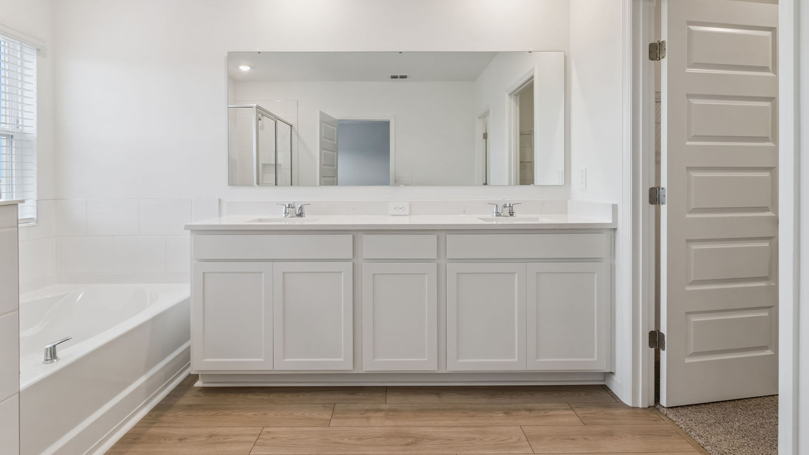 Primary Bathroom with dual vanity sinks and soaking tub