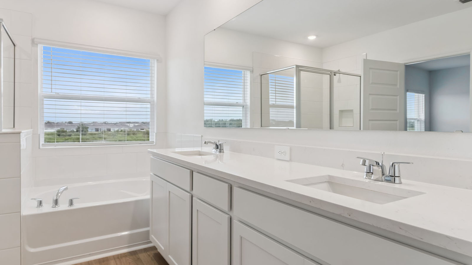Primary bathroom with soaking tub and window