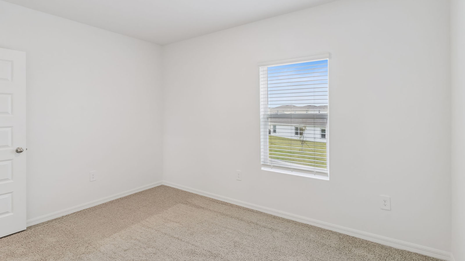 Bedroom 2 with window and carpet flooring