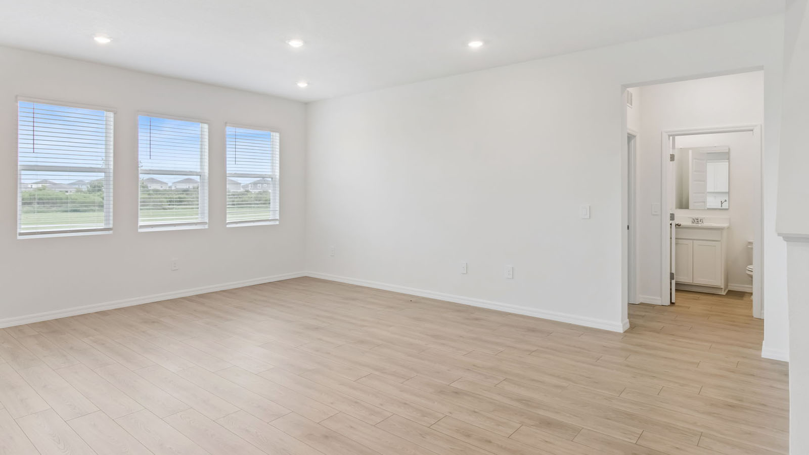 Living room with 3 windows and RevWood flooring