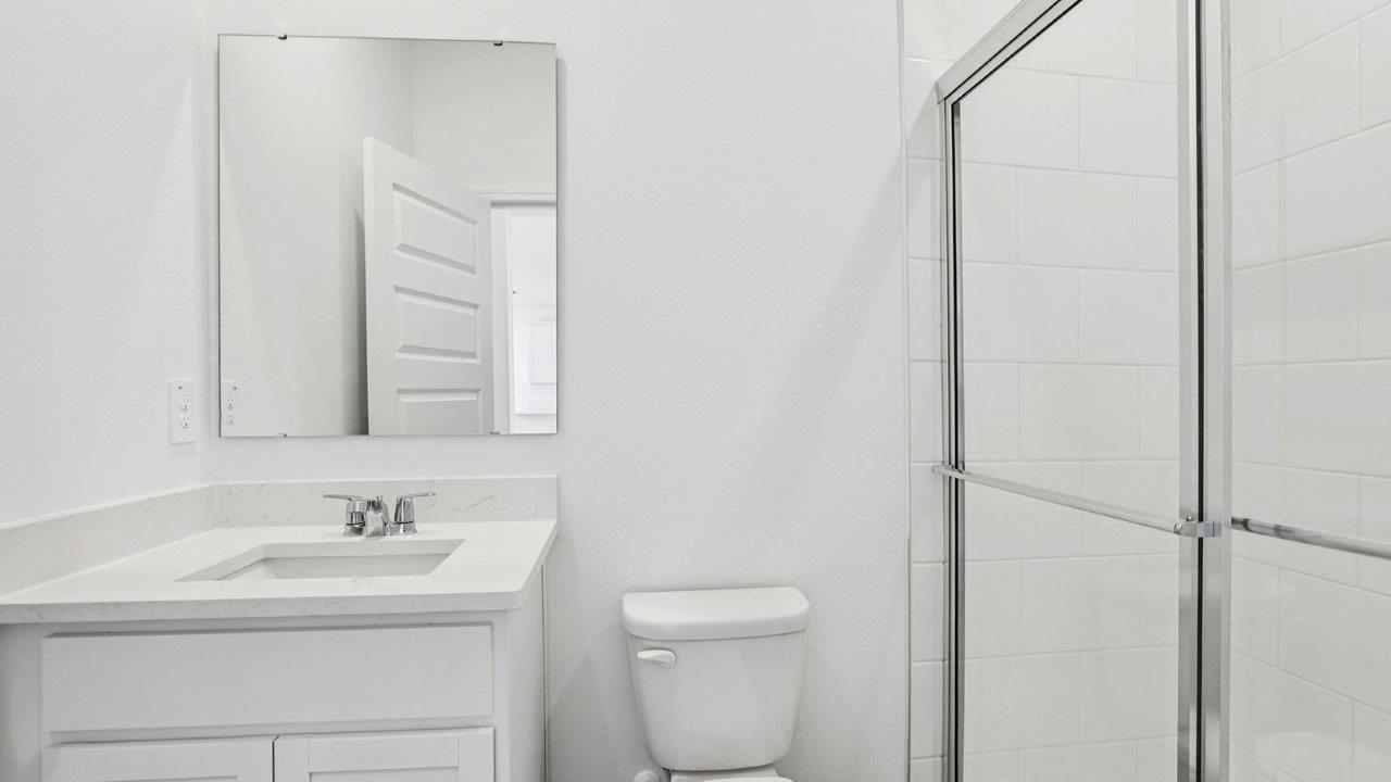 guest bathroom with single sink and walk in shower