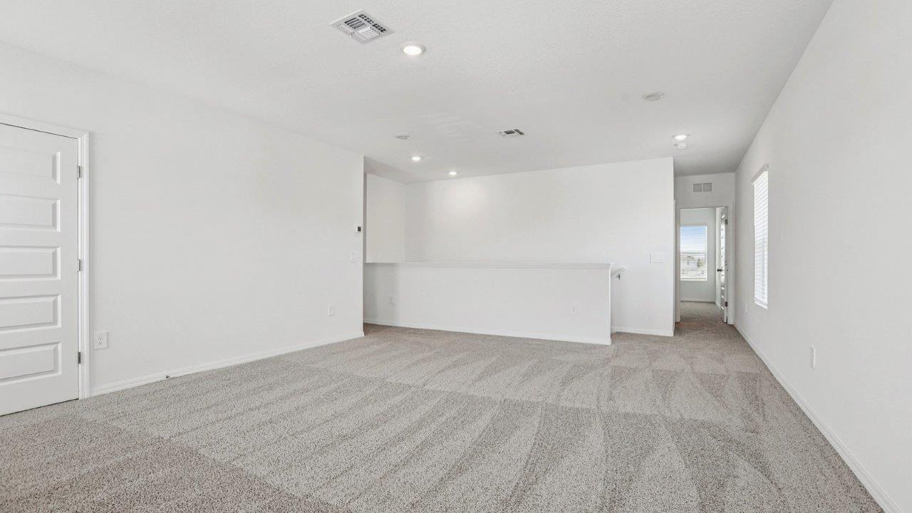 Upstairs loft with carpet flooring