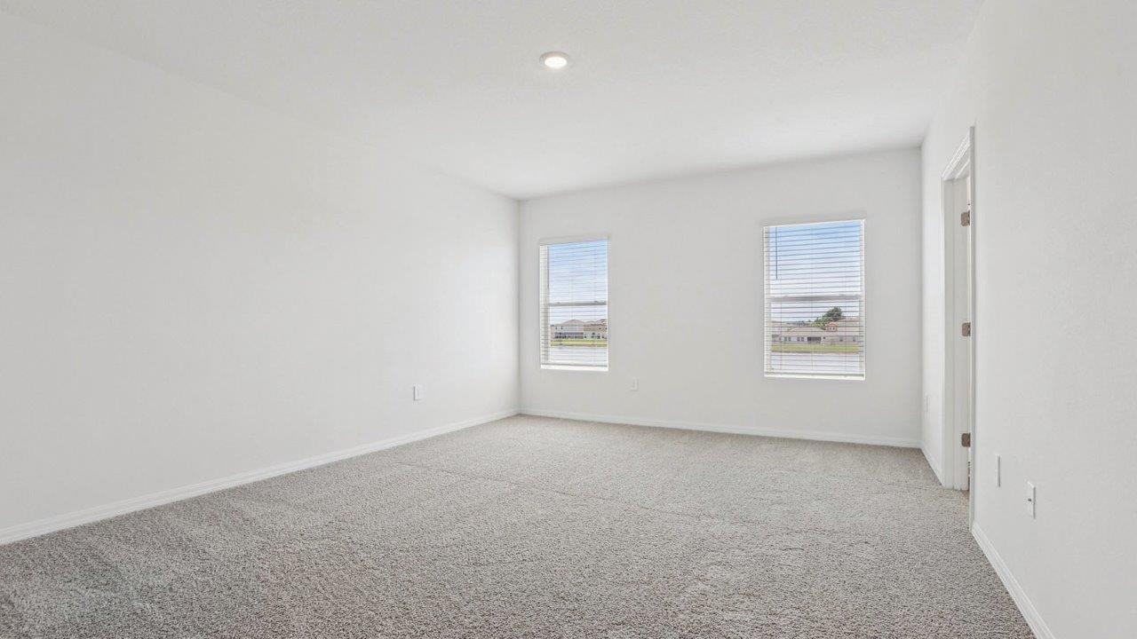 primary bedroom with carpet flooring