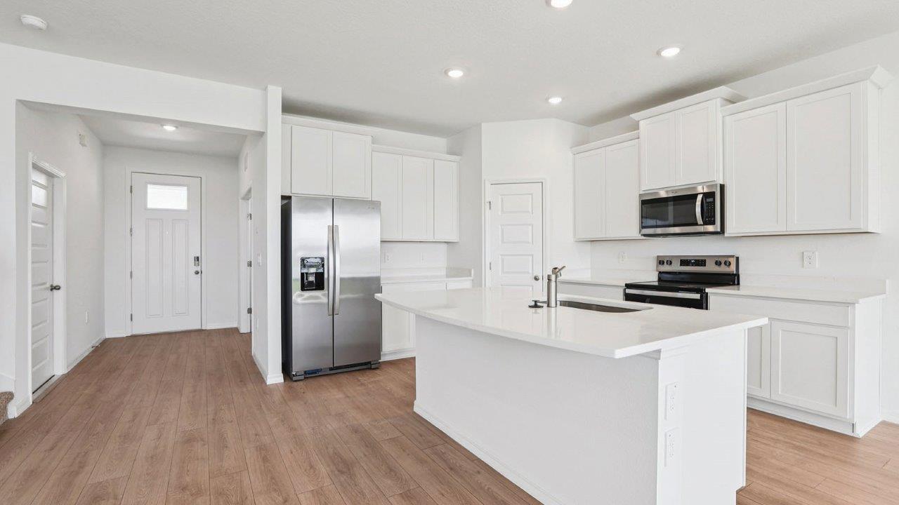 Kitchen with stainless steel appliances and revwood flooring