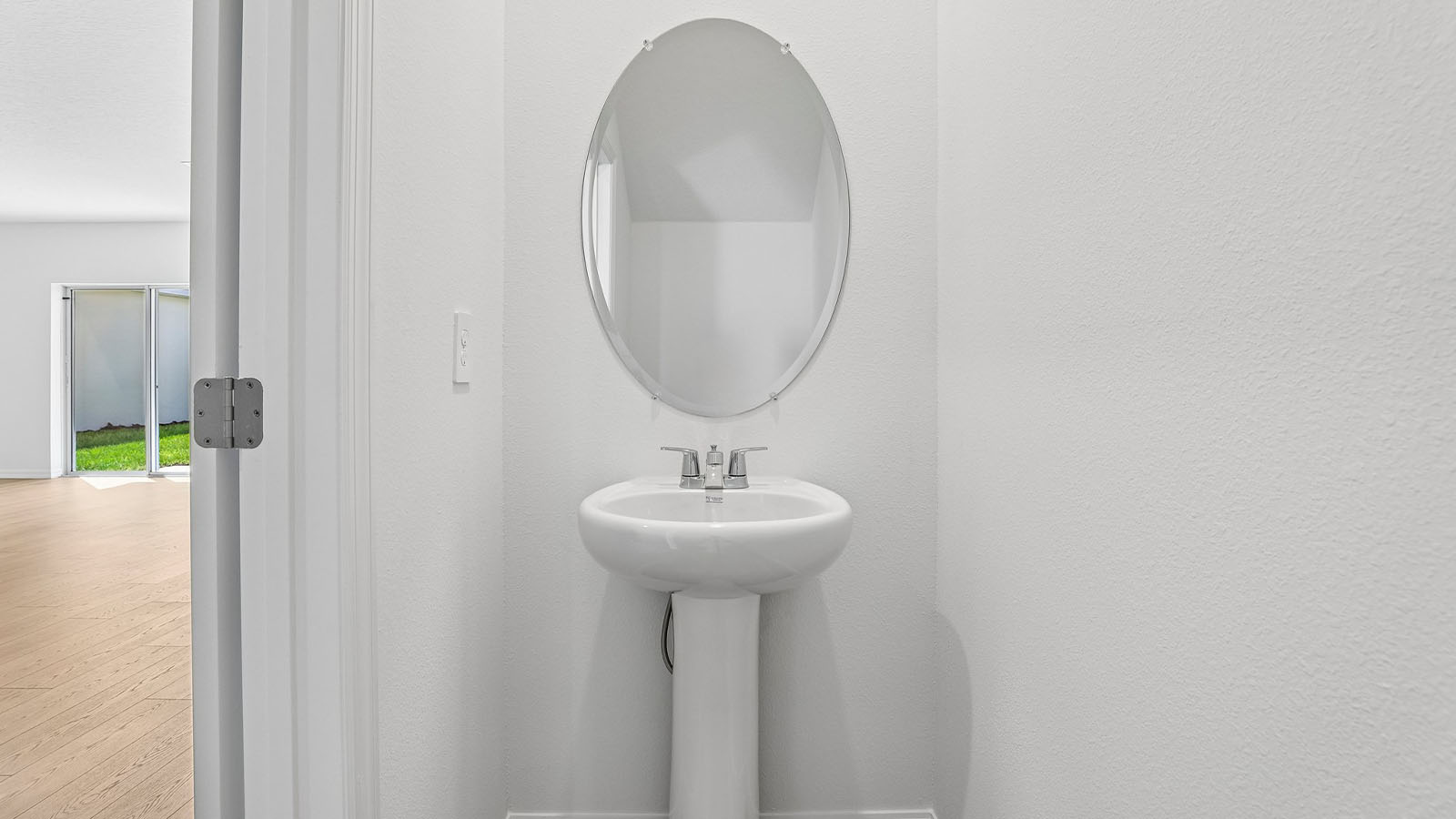 Downstairs half bathroom with pedestal sink