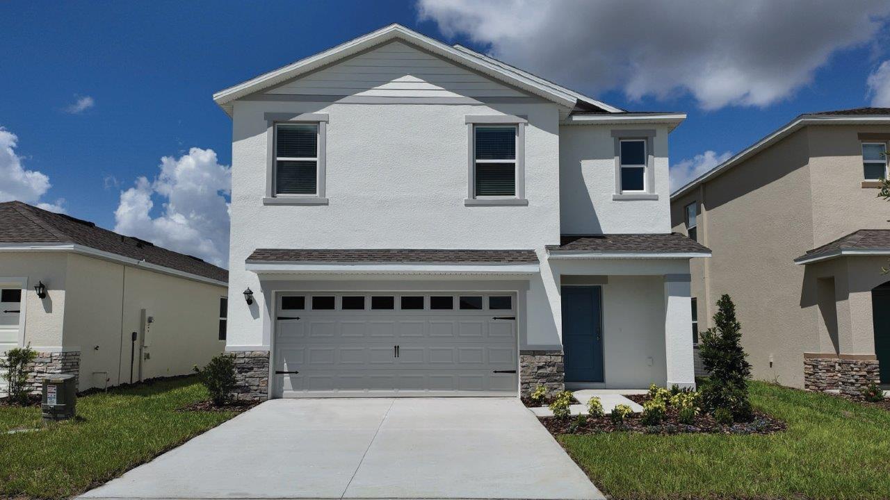 Exterior single family two-story home with stone accents