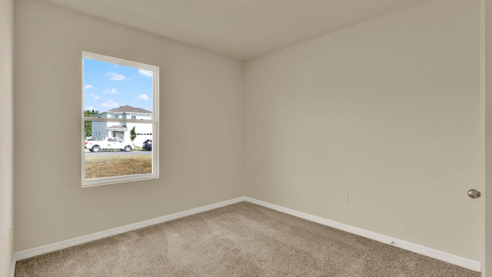 Guest bedroom with large window and carpet