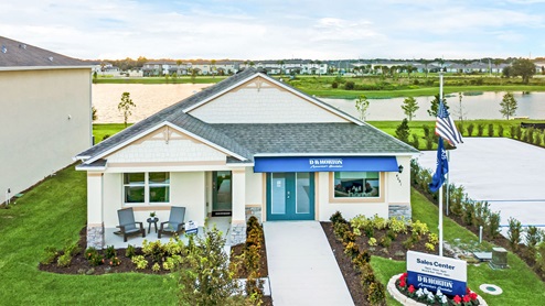 Exterior of the sales center with a lake view