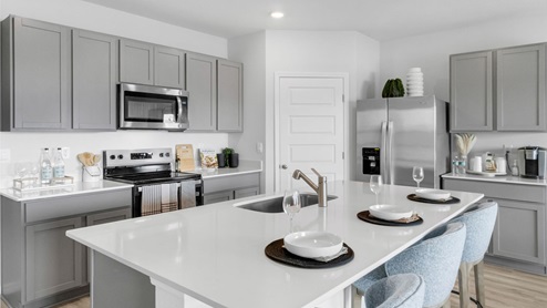 Kitchen with stainless steel appliance and luxury vinyl planks