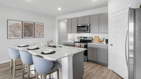 Kitchen with stainless steel appliance and luxury vinyl planks