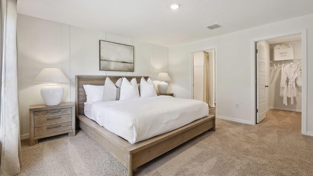 Primary bedroom with king size bed, walk-in closet, and attached primary bedroom