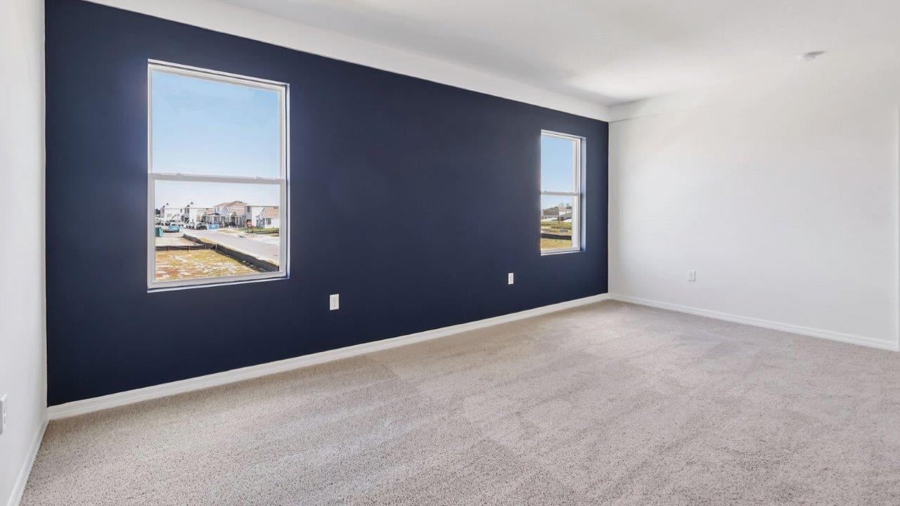 Primary bedroom accent wall with windows